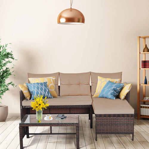 3-piece outdoor wicker sectional sofa set with beige cushions and glass coffee table in a living space