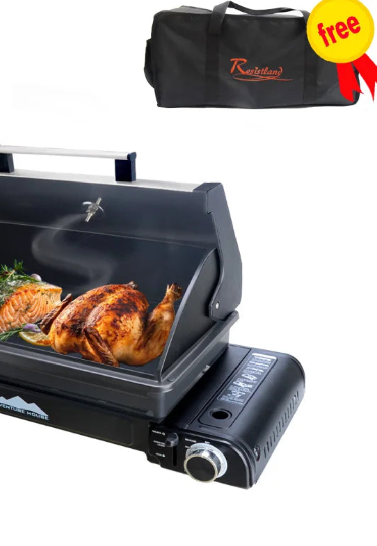 Portable gas grill cooking a roast chicken with included carry bag